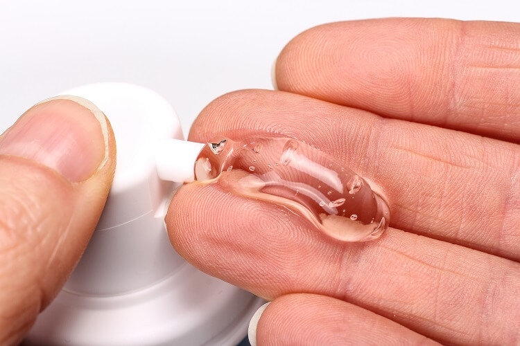 A man dispenses Testostorone Gel on his fingers, preparing to apply it.